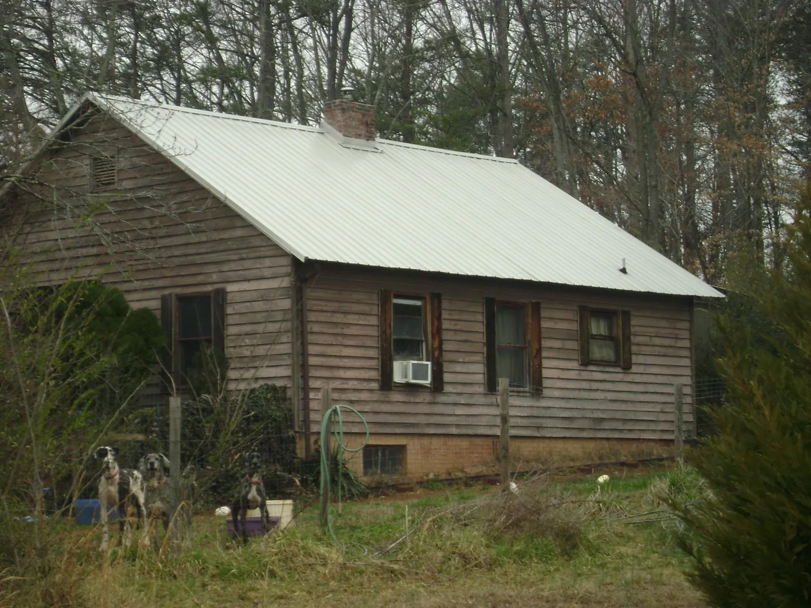 White metal roof on an old wood sided farmhouse, from a Metal Roof Installation job in Grove City